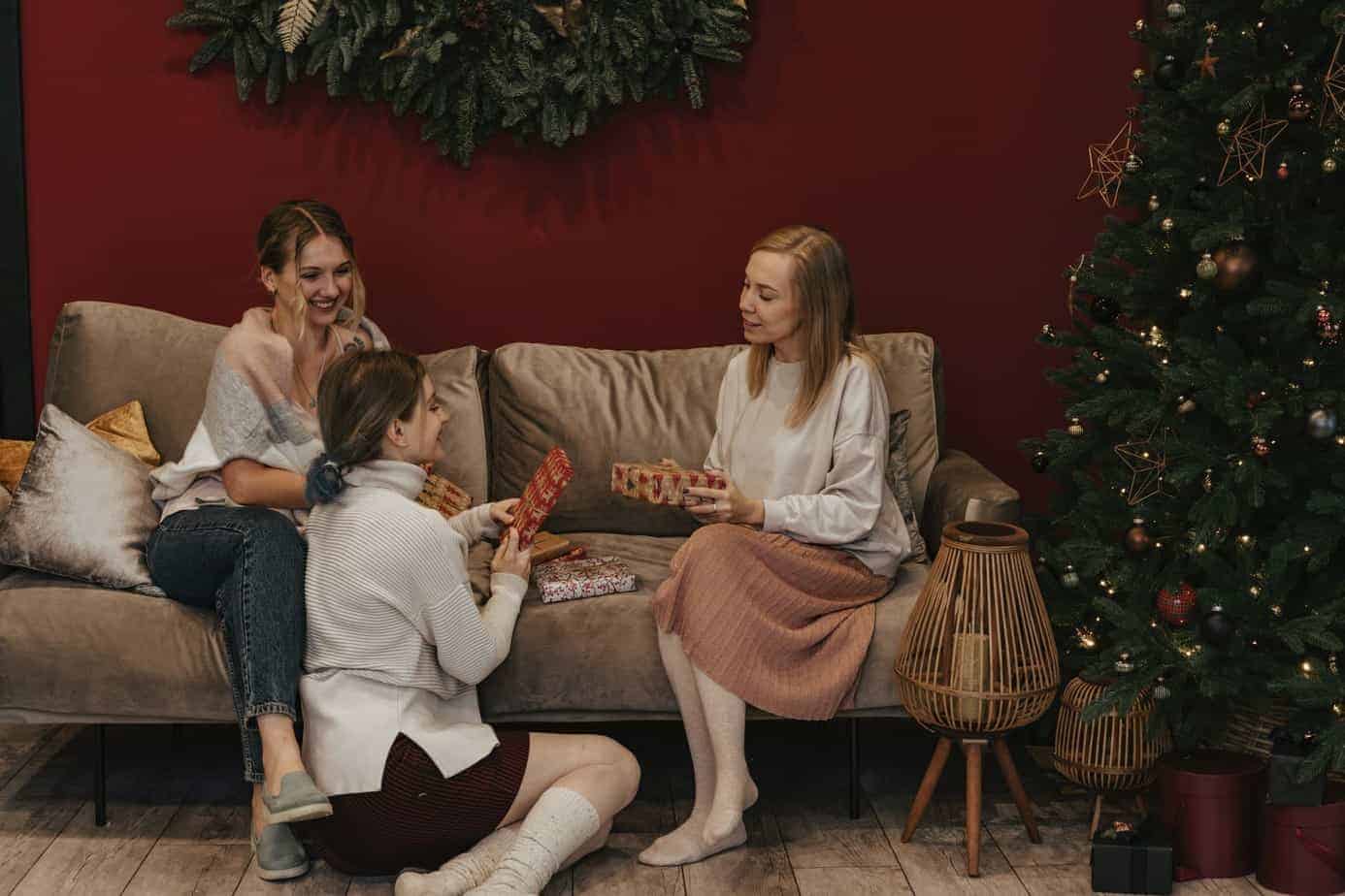 women in living room holding gifts